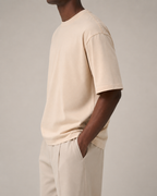 The Comfort Fit in Mother of Pearl — oversized Suvin cotton t-shirt on model, side view.