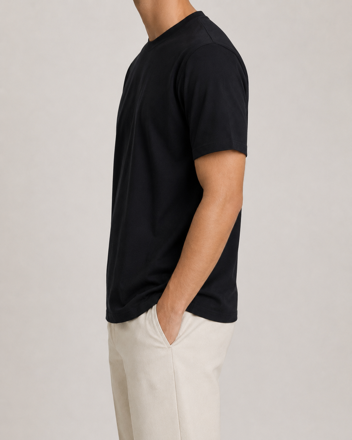The Standard Fit in Black — classic-fit Suvin cotton t-shirt on model, side view.
